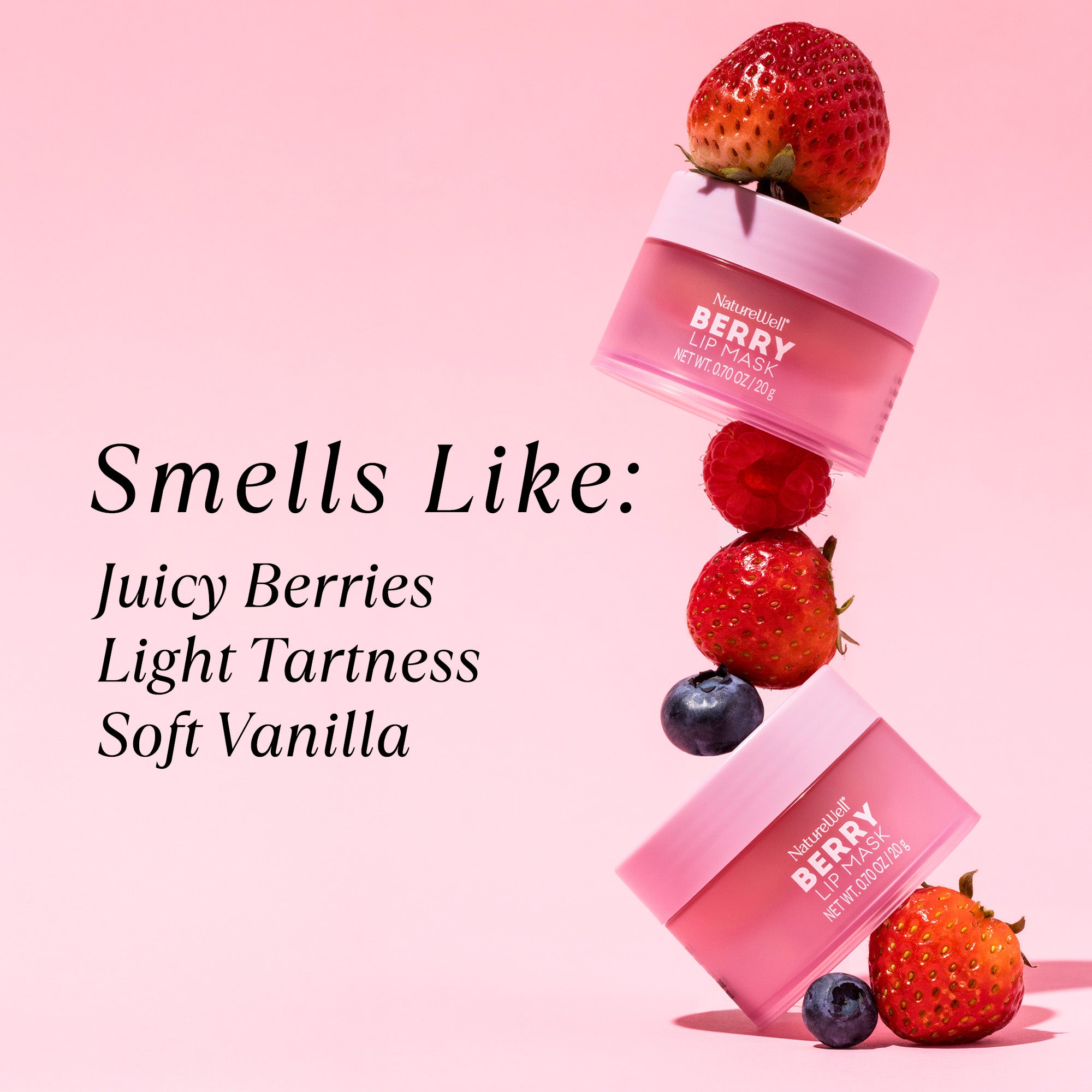 Jars of NatureWell Berry Lip Mask on a light pink background surrounded by berries