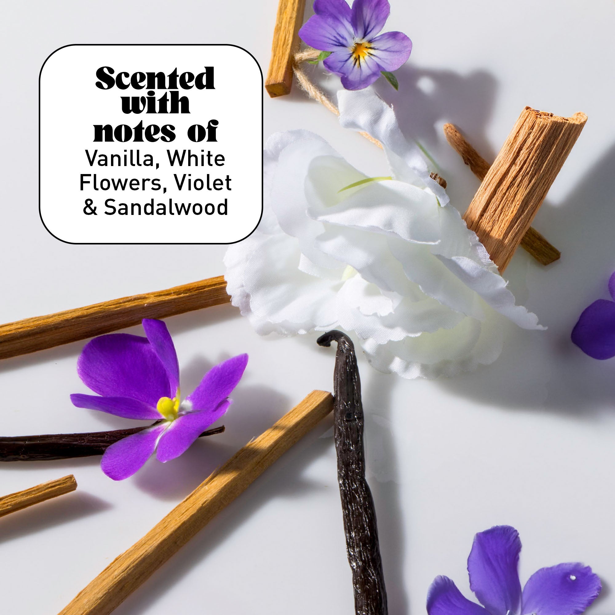 White flowers, vanilla beans, and violets on a white background with text overlay