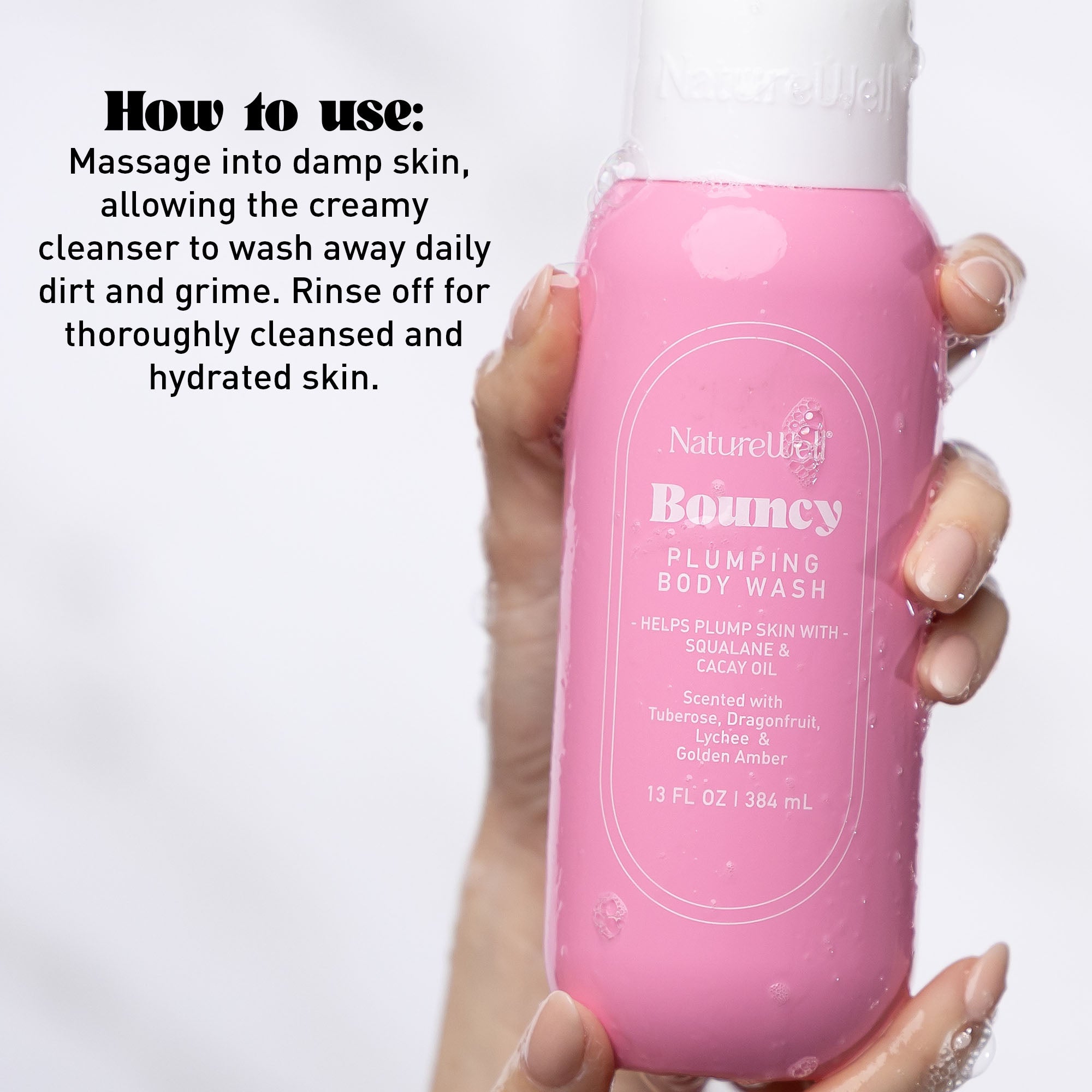 Woman holding a bottle of NatureWell Bouncy Plumping Body Wash on a white background with text overlay