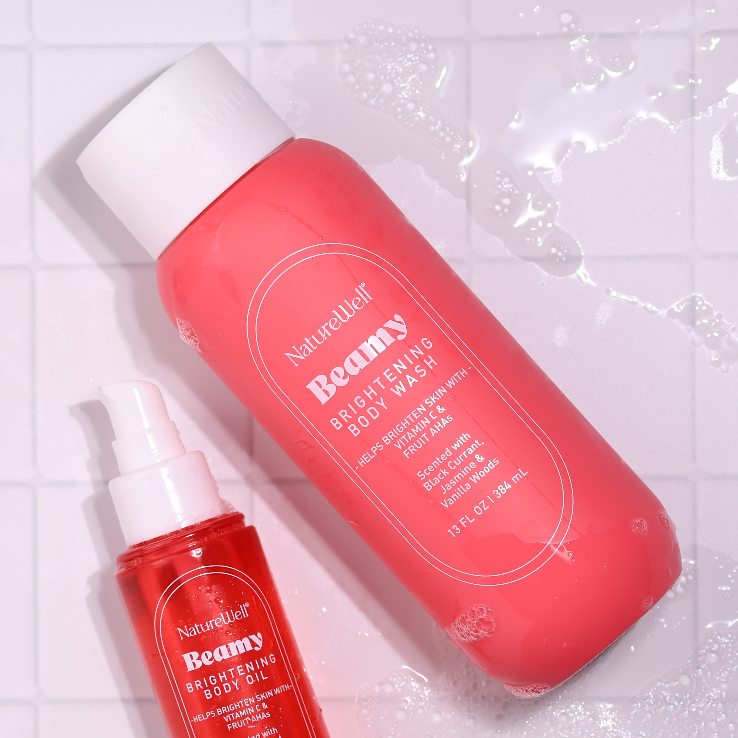 Bottle of NatureWell Beamy Brightening Body Wash aside a bottle of Beamy Brightening Body Oil