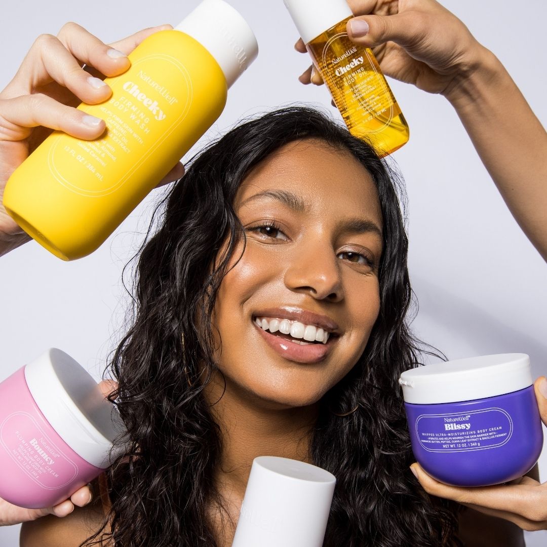 Woman holding a variety of NatureWell skincare products near her head