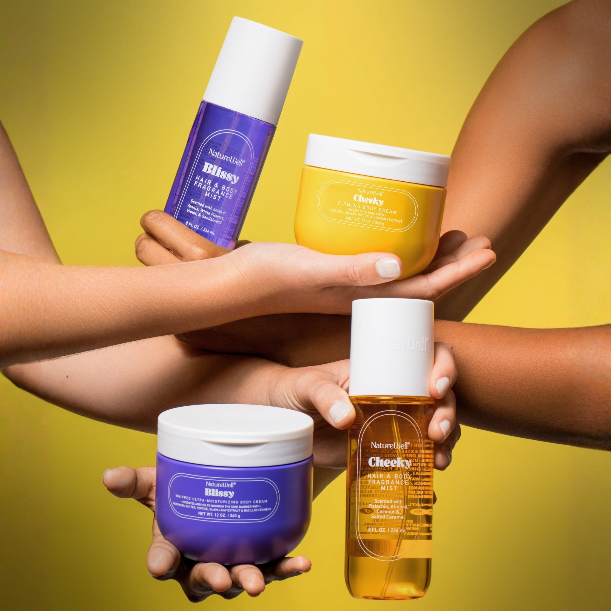 Women holding an assortment of NatureWell skincare products against a yellow background