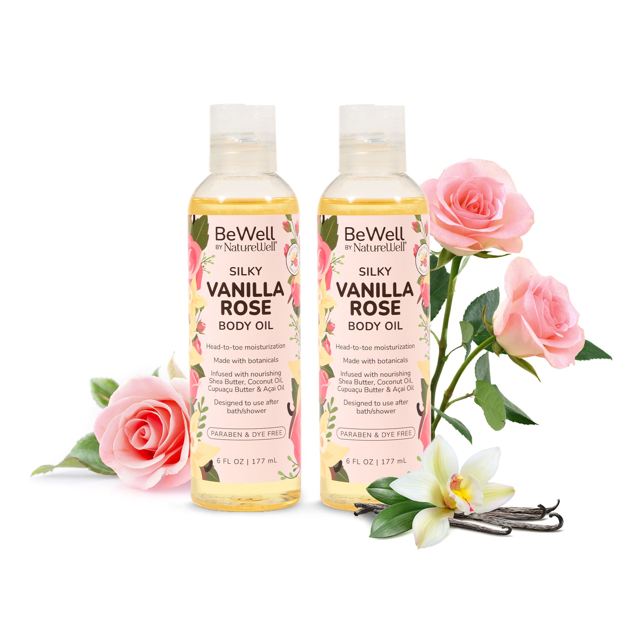 bottle of silky vanilla rose body oil and moisturizing coconut body oil next to pink roses, a white gardenia and vanilla beans
