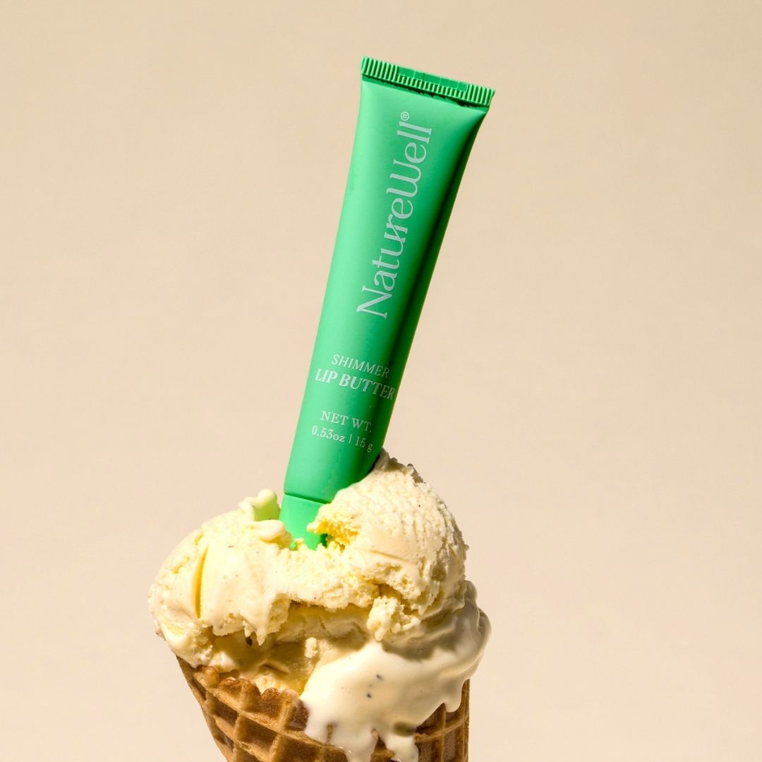 Green tube of NatureWell Vanilla Mint Lip Butter on top of a vanilla ice cream cone