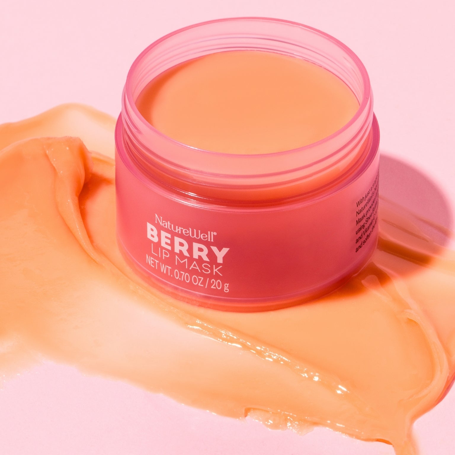 Open jar of NatureWell Berry Lip Mask with a swatch of product showing color and texture