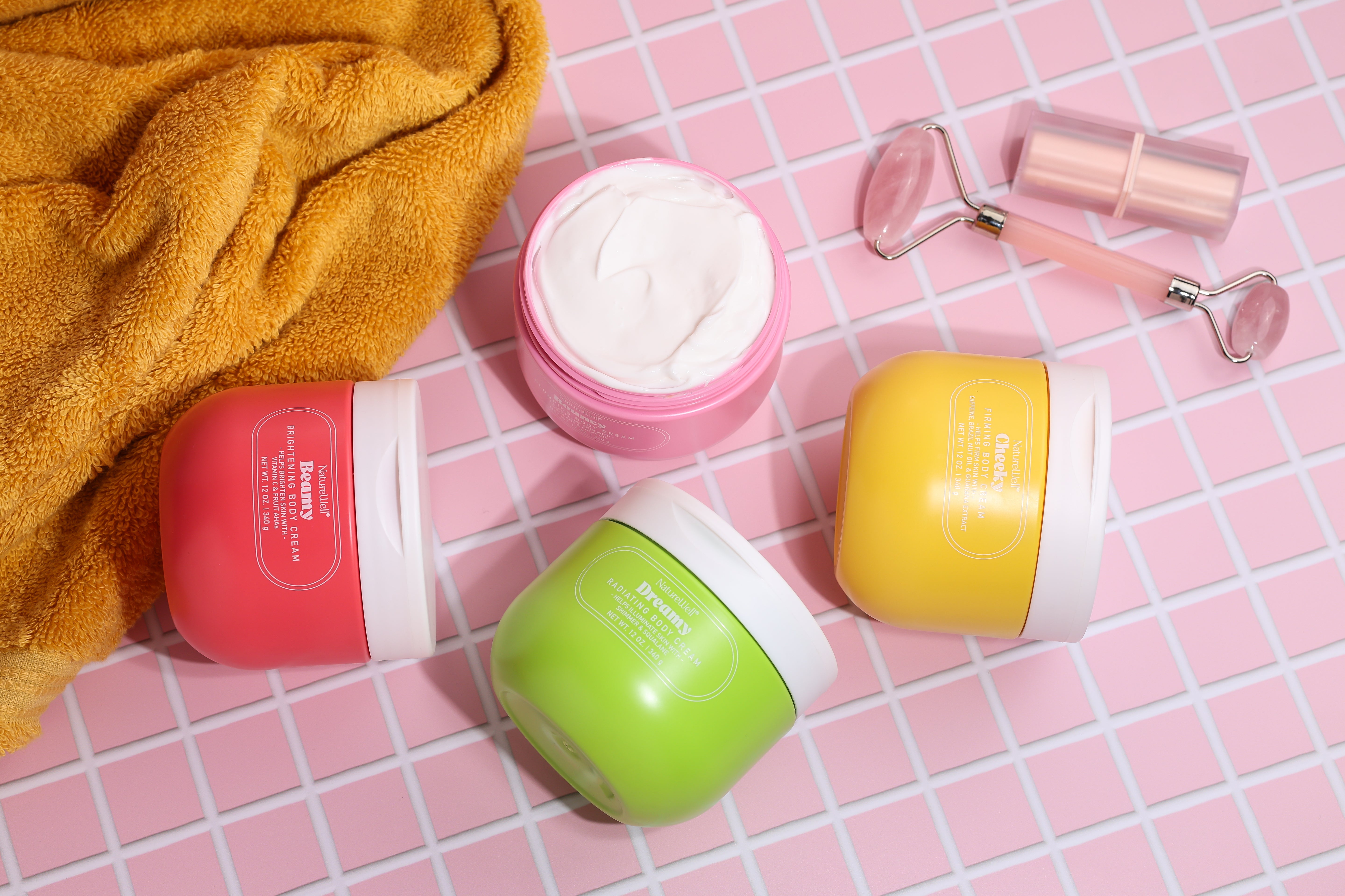 Colorful assortment of 4 jars of NatureWell Body Creams in Cheeky, Bouncy, Dreamy, and Beamy scents