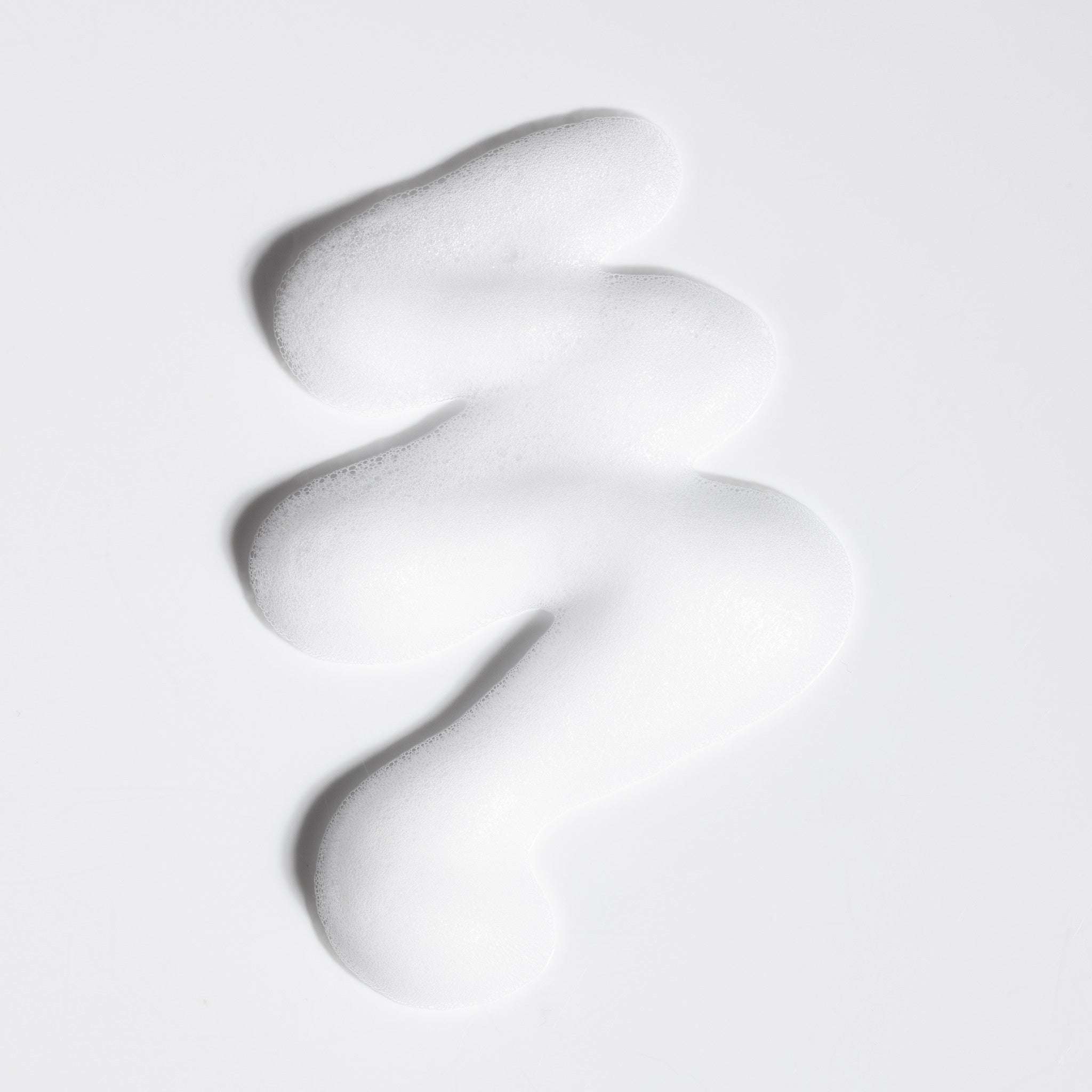 Close-up swatch of NatureWell SunRise Mousse on a white background