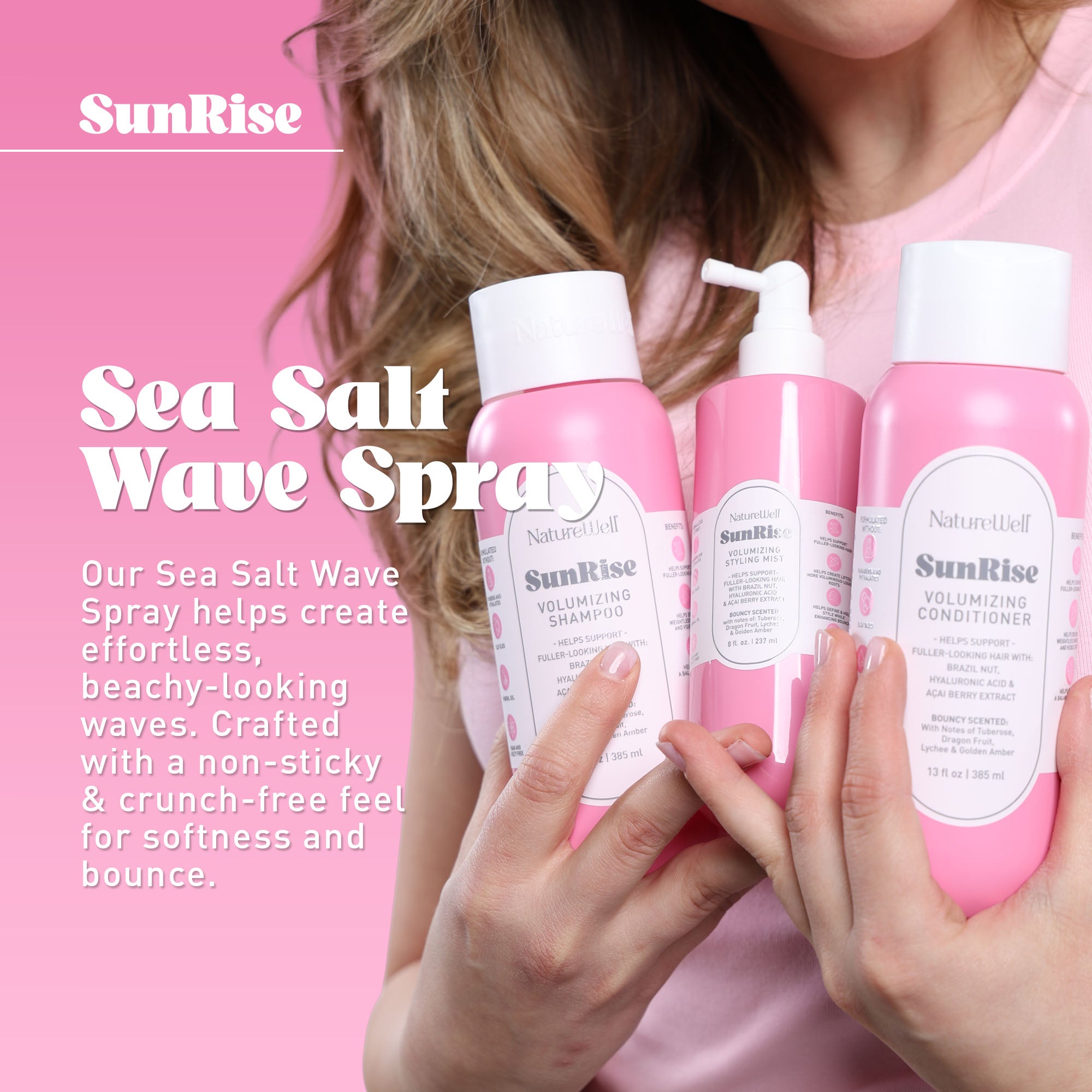 Woman holding a collection of NatureWell SunRise haircare products on a pink background with text overlay