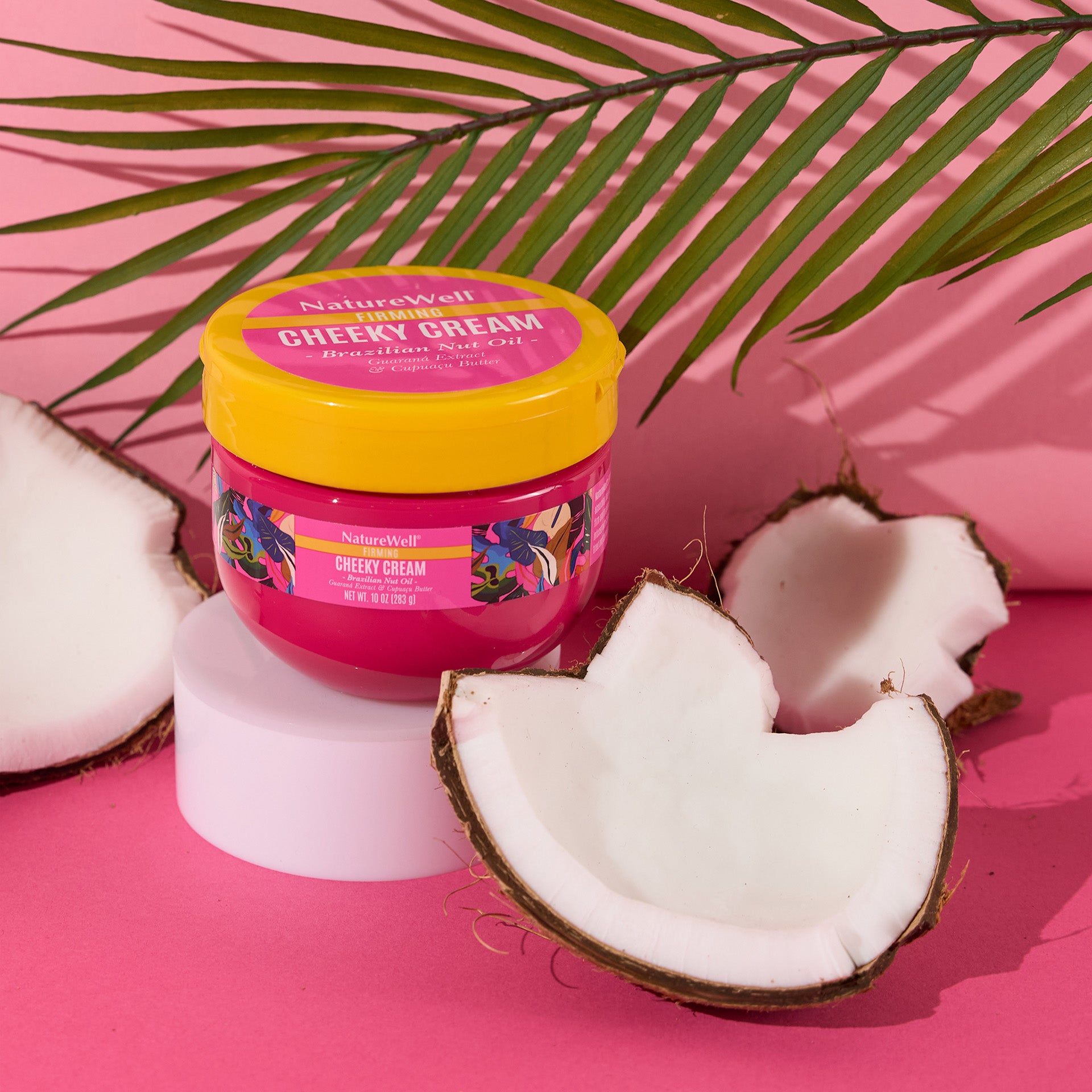 jar of coconut-scented firming cream next to coconuts