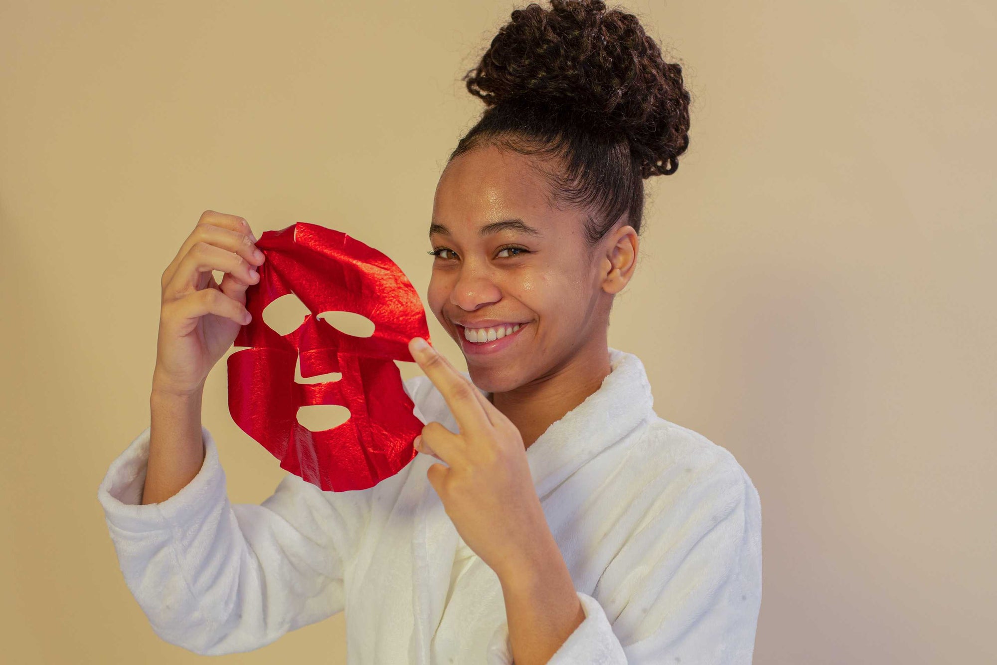 woman using skincare face mask