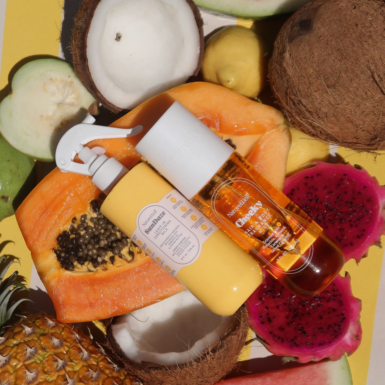 NatureWell haircare products on a background of fresh tropical fruits