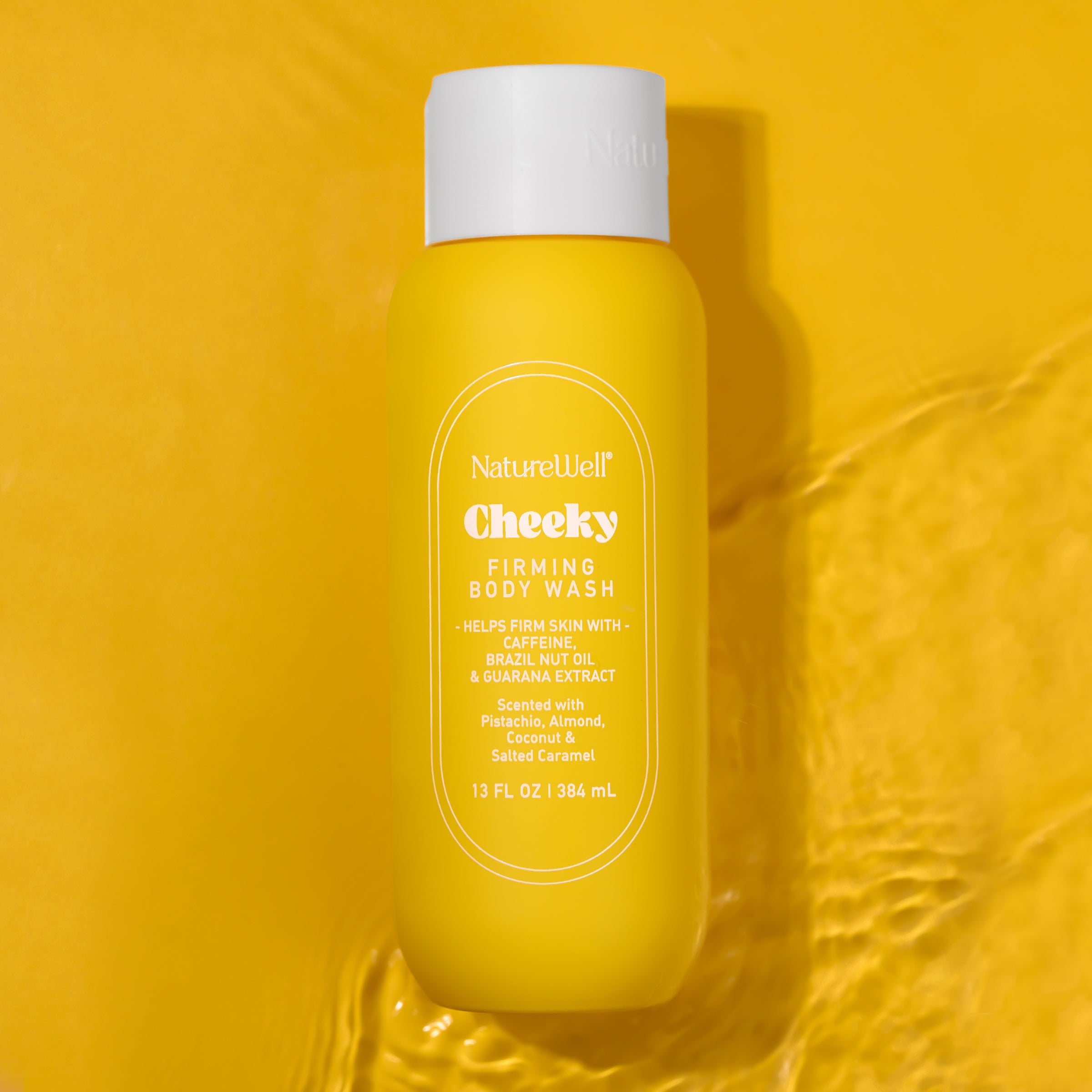 Bottle of NatureWell Cheeky Firming Body Wash on a yellow background