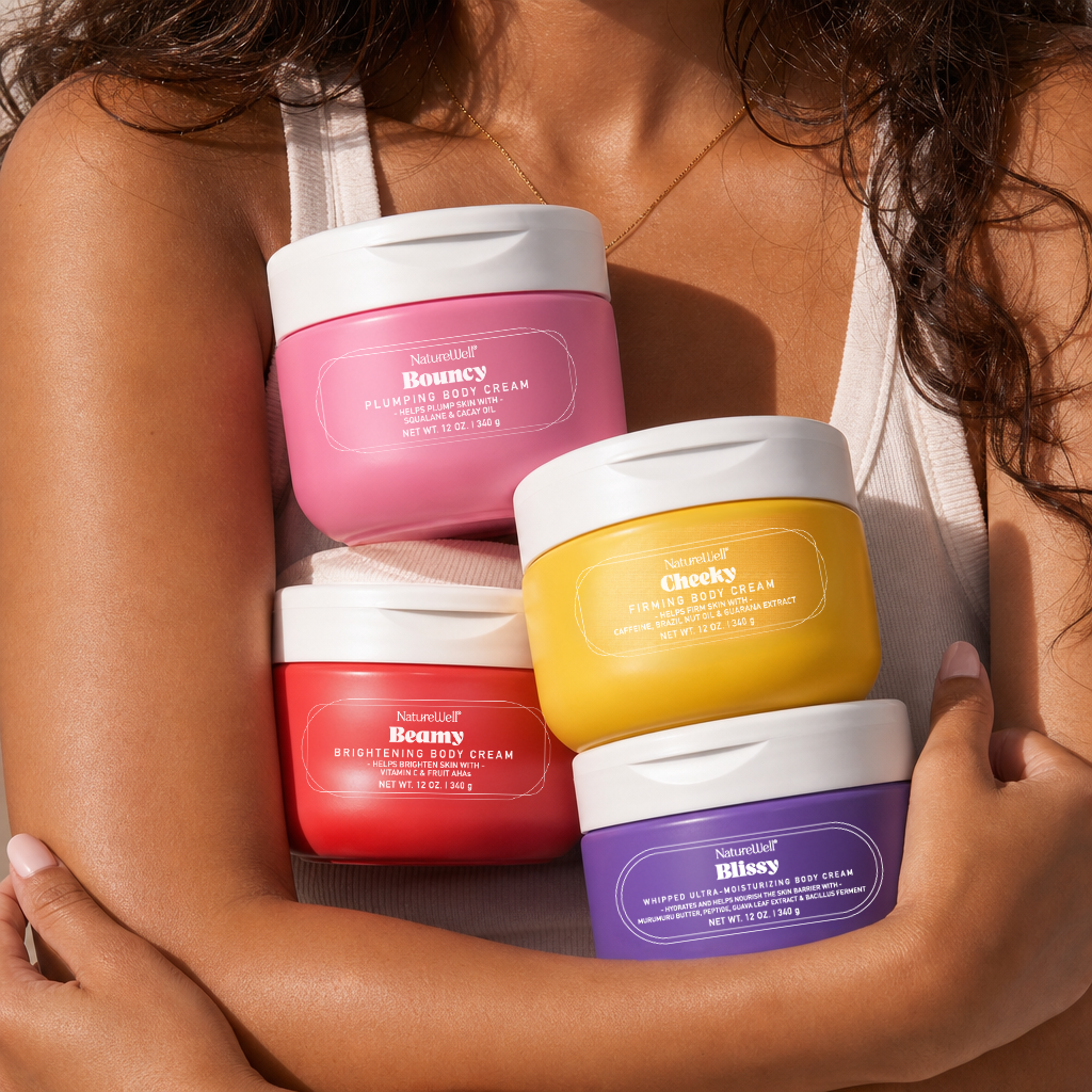 Woman holding jars of NatureWell body creams in her arms