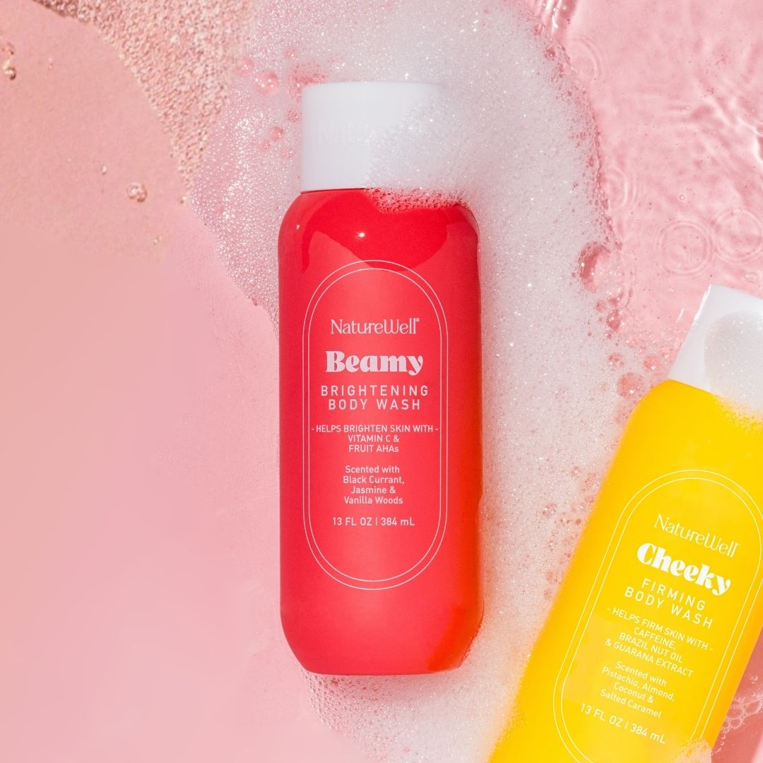 Bottle of NatureWell Beamy Brightening Body Wash surrounded by suds