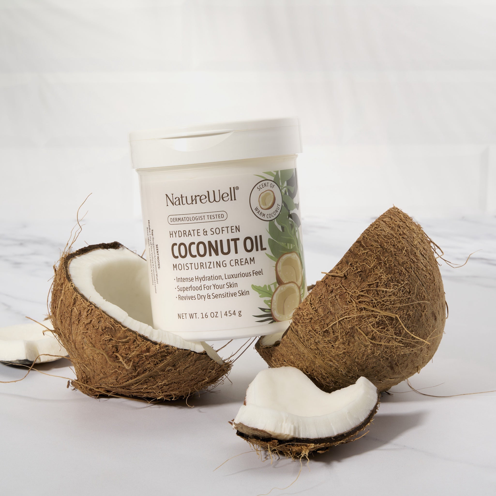 Jar of NatureWell Coconut Oil Moisturizing Cream on top of a cracked open coconut