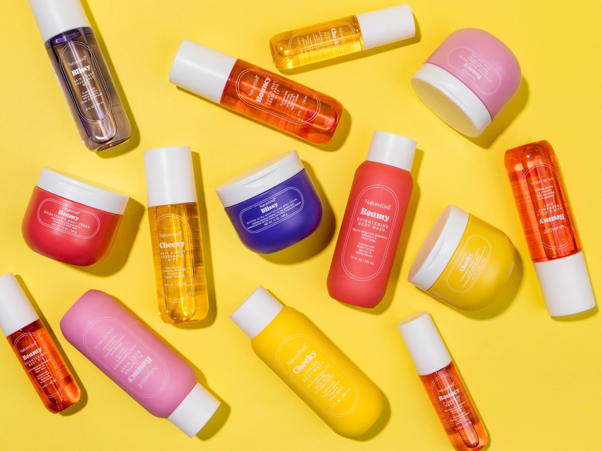Assortment of NatureWell body and skin care products on a yellow background