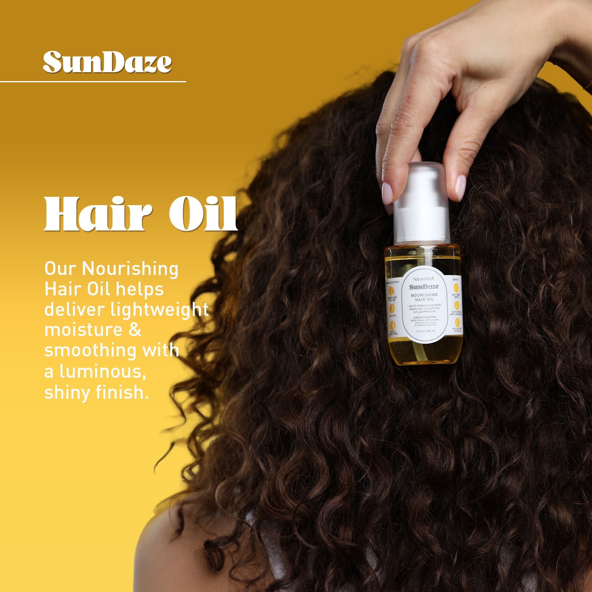 Woman holding a bottle of NatureWell SunDaze Nourishing Hair Oil next to her curly brown hair