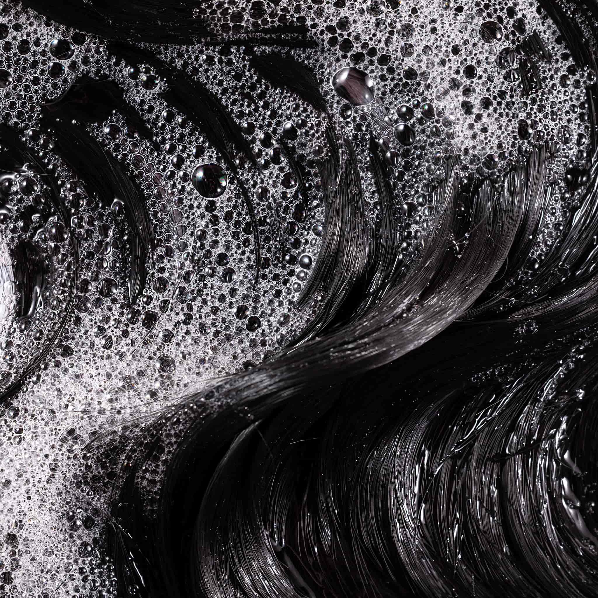 Sudsy lather on dark brown hair