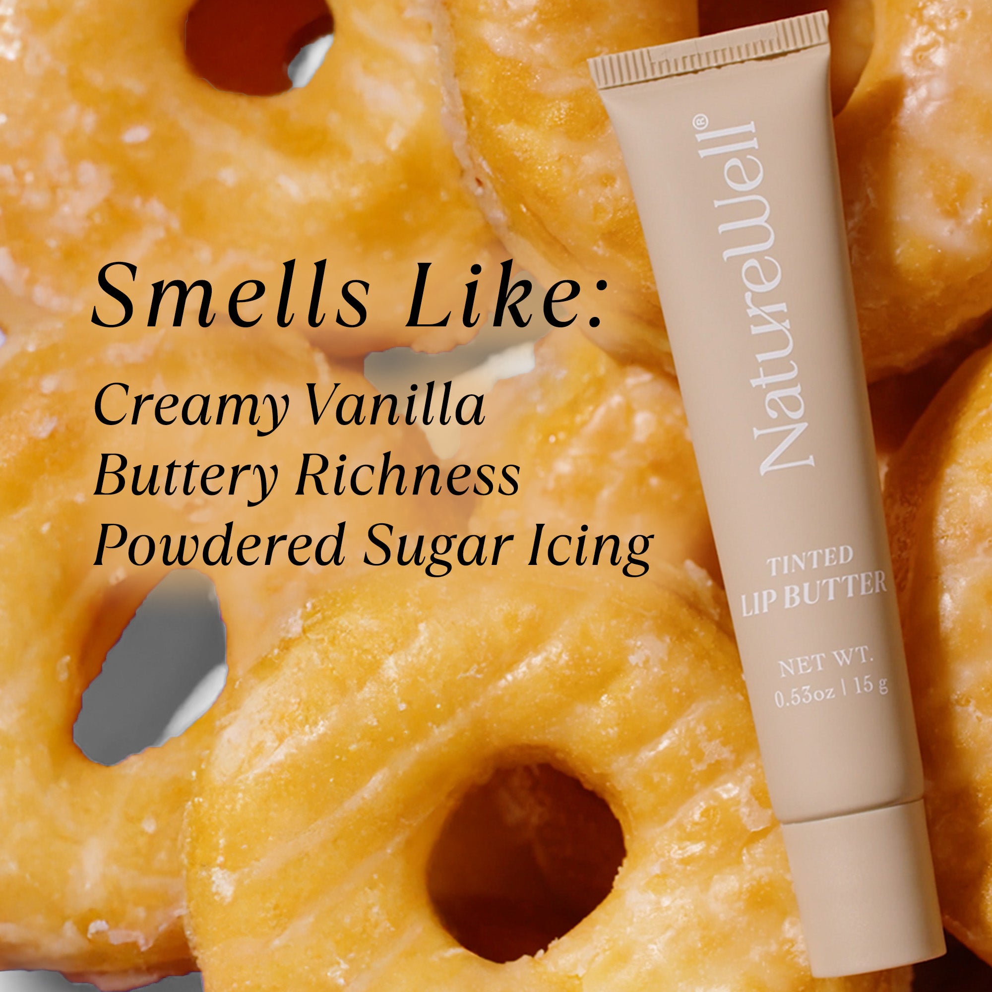 Tube of NatureWell Vanilla Glaze Tinted Lip Butter on a background of vanilla glazed donuts