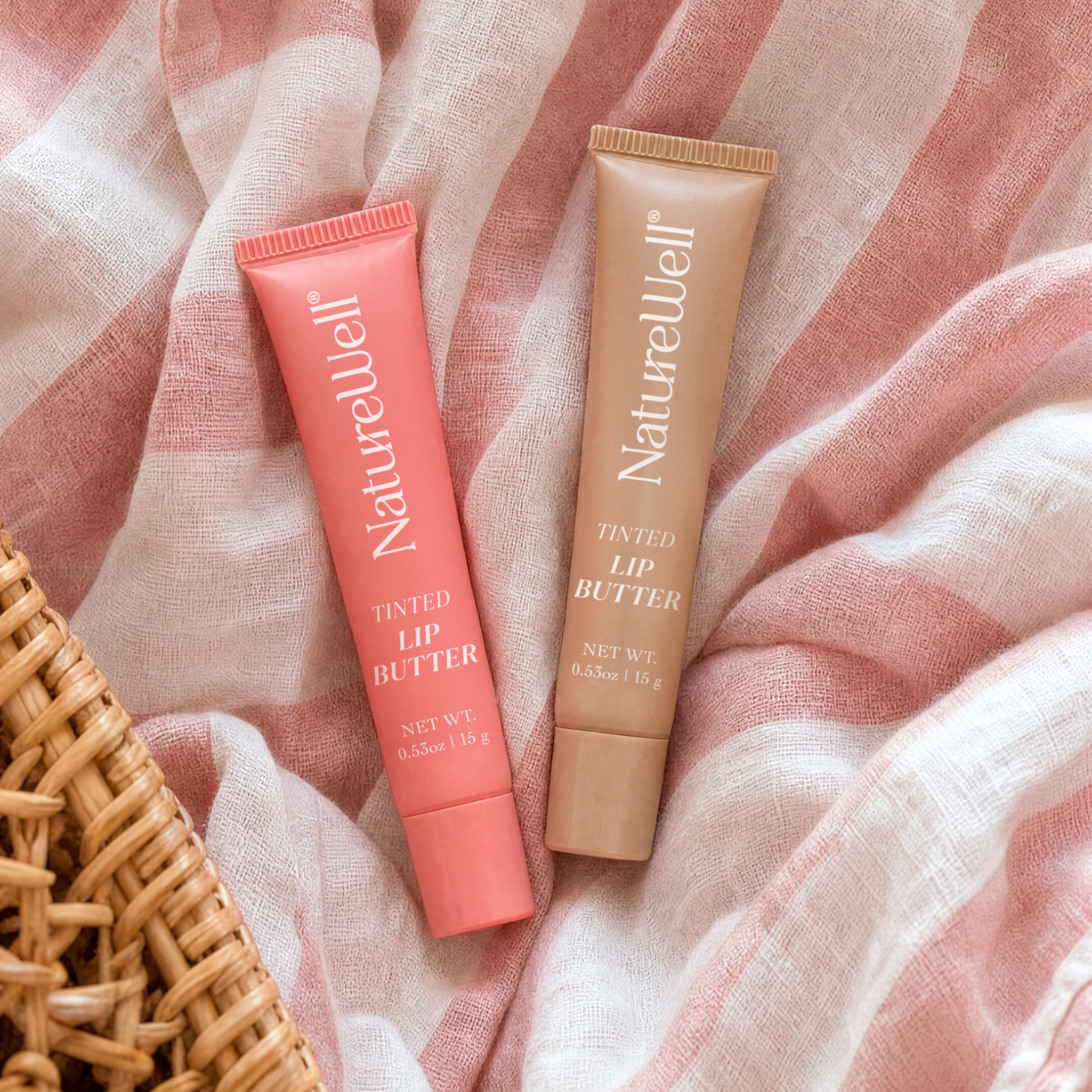 Tubes of NatureWell Lip Butters on a pink background