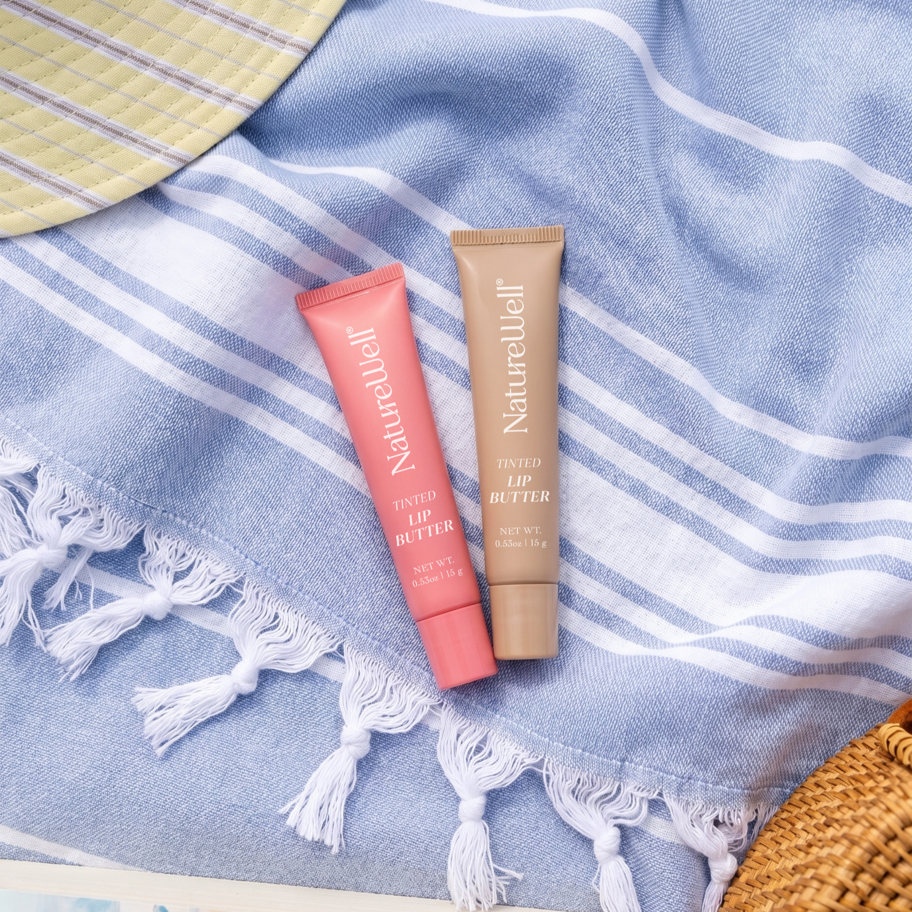 Tubes of NatureWell Lip Butters on a blue background