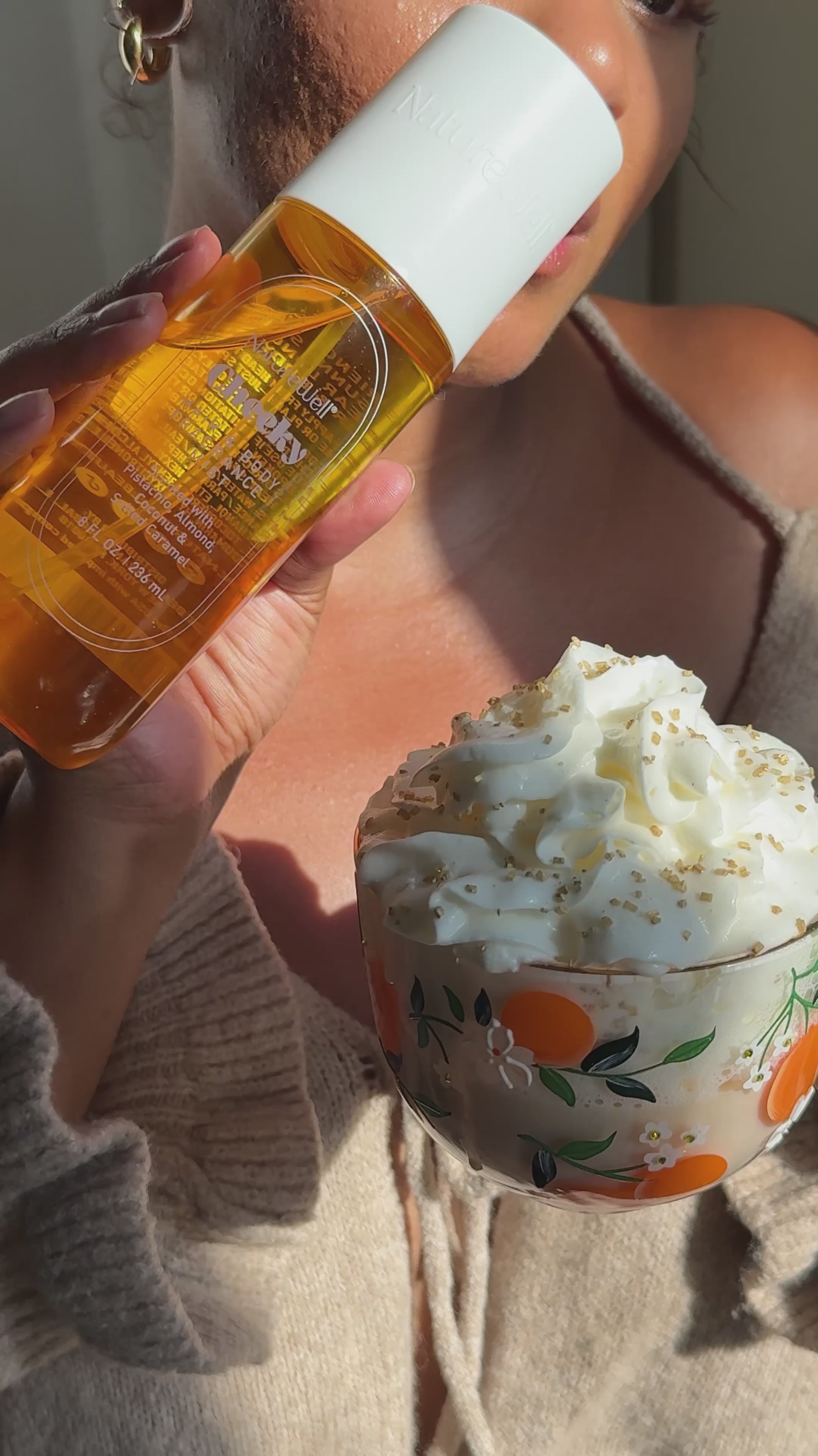 Woman making a cup of tea and using her NatureWell Cheeky Hair & Body Fragrance Mist