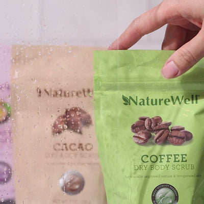 Woman applying NatureWell Exfoliating Dry Body Scrub to her body