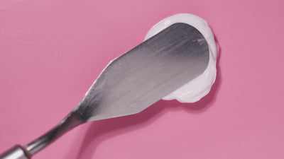 Swipes of NatureWell Beamy Brightening Body Creams being applied to surface