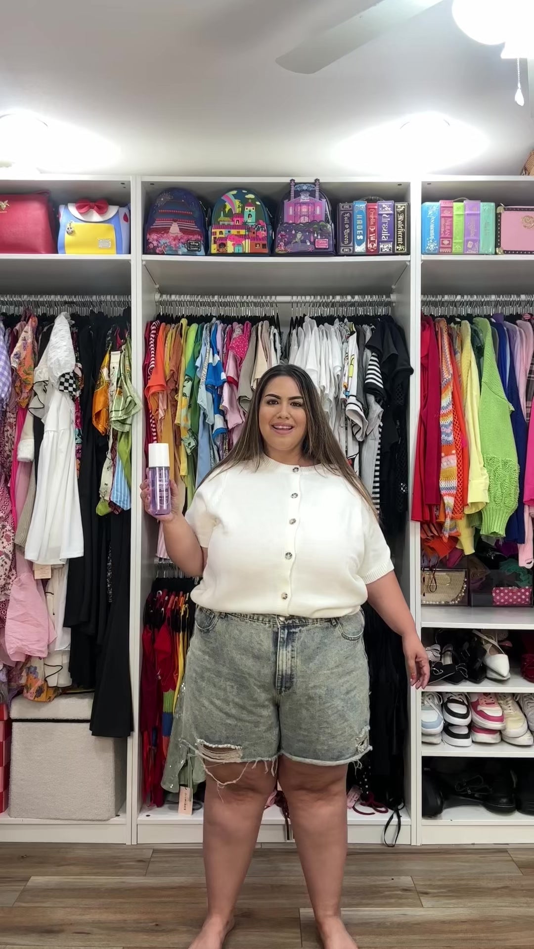 Smiling woman spritzing NatureWell Blissy Hair & Body Mist Fragrance  all over herself.