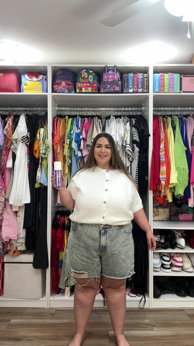 Smiling woman spritzing NatureWell Blissy Hair & Body Mist Fragrance  all over herself.