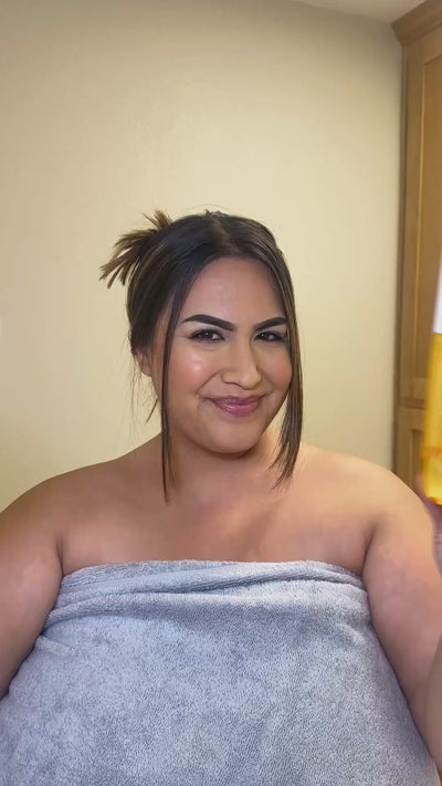 Woman showing her skincare routine using NatureWell Cheeky Firming Body Cream and Cheeky Firming Body Oil