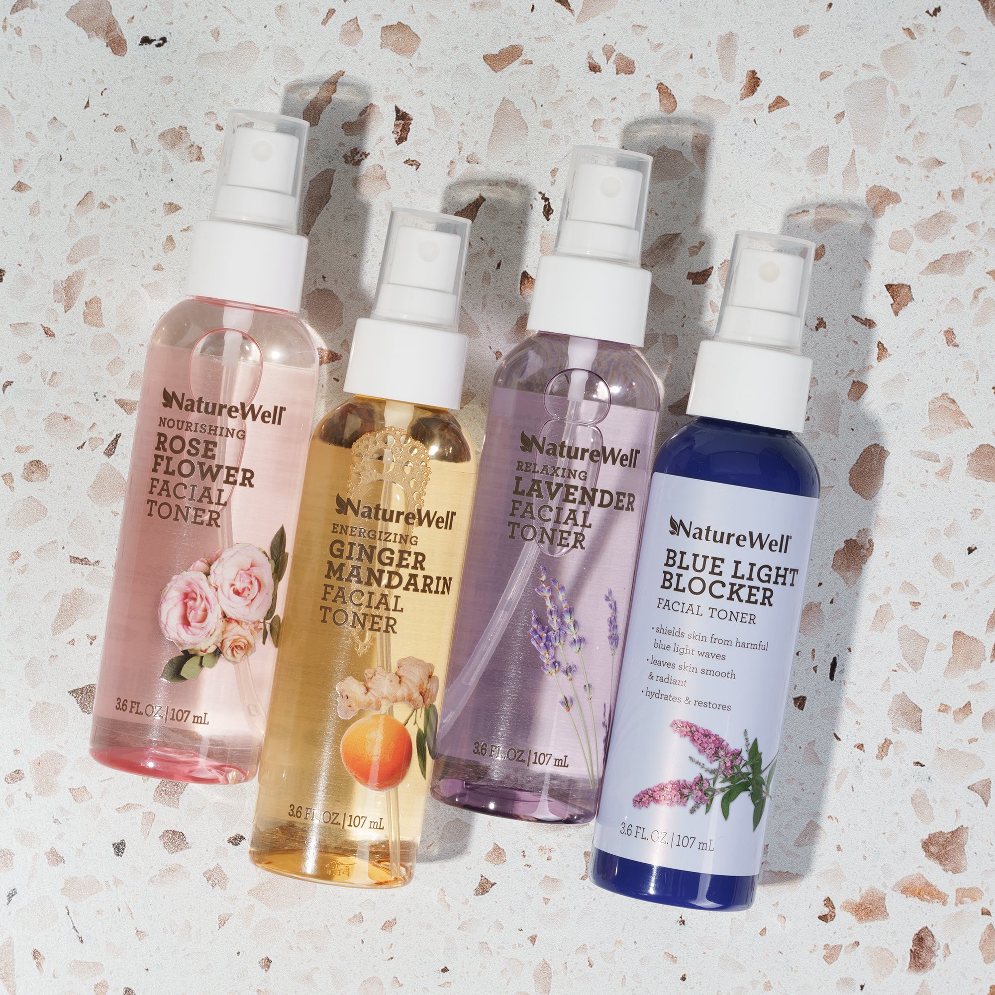 4 bottles of NatureWell Facial Toner Mists on a white background